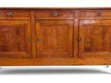 an old wooden sideboard with three doors and two drawers