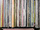 an open box filled with lots of different colored vinyl records