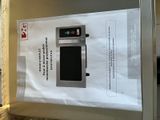a sign on a refrigerator that has a microwave in it