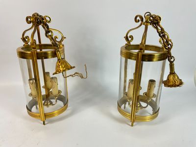 pair of antique brass and glass lanterns with bells on them