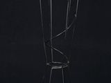 a black and gold coat rack with five coats on it