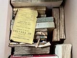 a cardboard box filled with books and papers on top of it