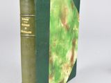 a book with a green cover sitting on a white surface