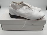 they are white shoes on a white box on a white surface