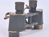 a pair of binoculars sitting on a white surface