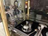 a display case with silverware and silver spoons on it