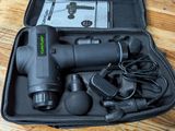 a black case with a corded cord and a corded cord in it on a wooden floor