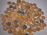a pile of gold and silver coins on a white surface