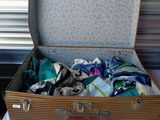 a suitcase full of clothes sitting on a bed