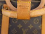 a brown and tan bag with a brown strap