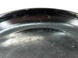 a close up of a metal plate with a white background