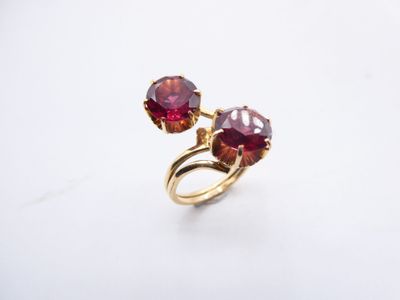 a close up of a ring with two red stones on it