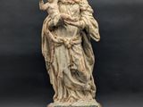 a statue of a woman holding a child in her arms