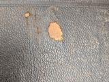 a close up of a piece of leather with a hole in it