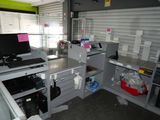 a desk with a computer and a printer on it