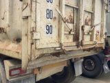 a dump truck that is parked on the side of the road