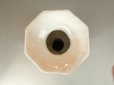 a small white object with a black hole in it