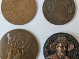 four different types of coins are shown on a white surface