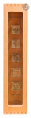 a wooden box with four bottles in it on a white background