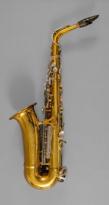 a gold saxophone with a black and white background
