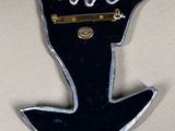 a picture of a black and silver brooch with a crown on it