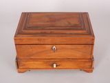 an old wooden box with a drawer on top of it