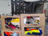 a cardboard box with clothes and other items in it