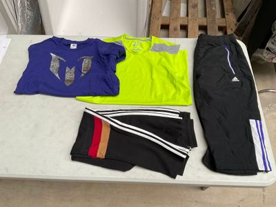 une table sur laquelle sont posés de nombreux vêtements