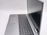 a silver laptop computer sitting on top of a white table