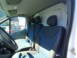 the interior of a white van with blue seats and a steering wheel