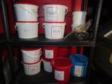 many buckets of different colors and sizes on a shelf