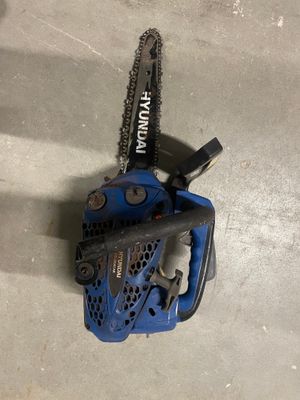 a blue chainsaw sitting on top of a cement floor
