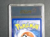 a pokemon card in a plastic holder on a table