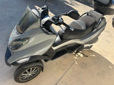 a scooter that is parked on the side of the road