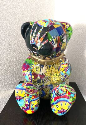 a colorful teddy bear sitting on top of a wooden table