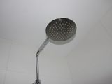 a shower head that is in the middle of a bathroom