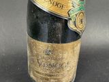 a bottle of wine with a gold label on it