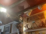 many pictures on the wall above the shelves in this room
