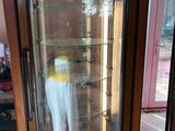 a glass display case with a white shirt in it