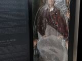 an open book with a picture of a man in a red coat
