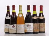 six bottles of wine are lined up in a row on a table