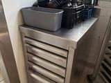 a kitchen with a stove, sink, and oven in it