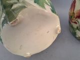 two vases that are sitting on a table