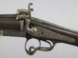 a very old gun with a very nice design on it