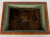 a small square wooden box with a brown substance in it