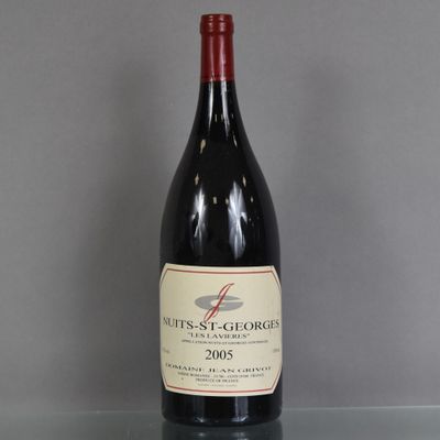 a bottle of wine sitting on a glass table