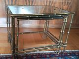 two tables that are sitting on a rug on the floor