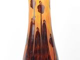 a vase that is sitting on a white surface