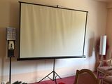 a large projection screen in the middle of a room