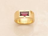 yellow gold ring with a garnett stone in the center